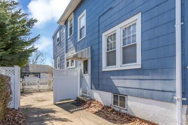 view of side of property featuring fence