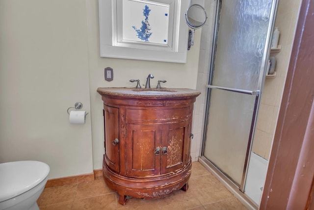 bathroom with vanity, baseboards, a stall shower, tile patterned floors, and toilet