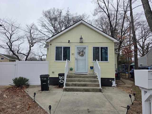 bungalow with a gate, fence, and entry steps