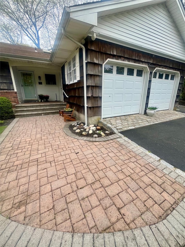 view of home's exterior featuring driveway and a garage