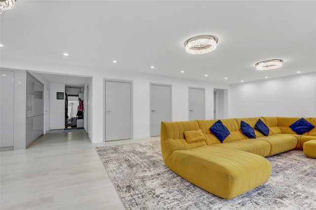 living area with recessed lighting and light wood-style floors