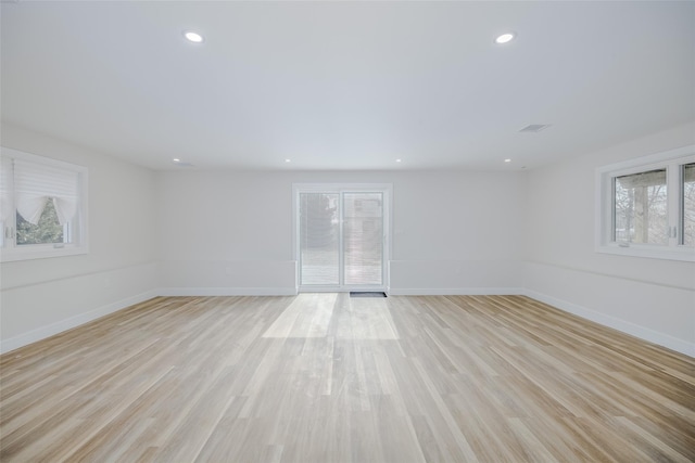 empty room with baseboards, light wood-style floors, and recessed lighting
