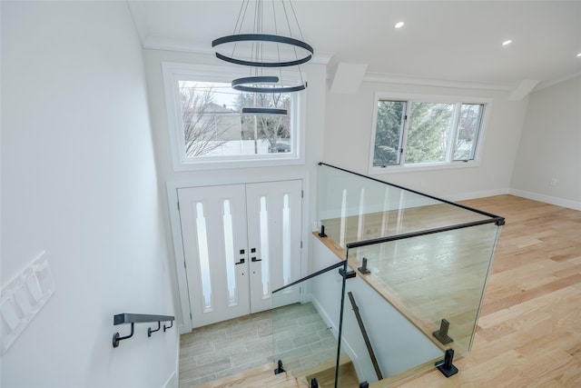 foyer featuring baseboards, recessed lighting, wood finished floors, and ornamental molding
