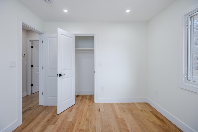 unfurnished bedroom with light wood finished floors, baseboards, and recessed lighting