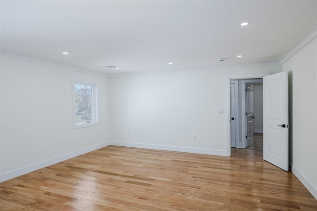 spare room with recessed lighting, crown molding, baseboards, and light wood-type flooring