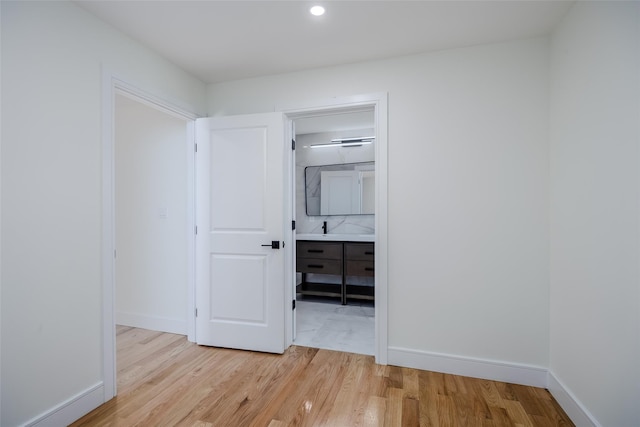 interior space with baseboards and light wood-style floors