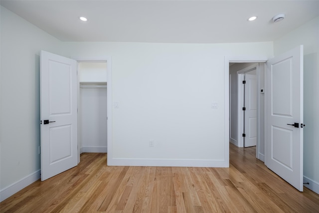 unfurnished bedroom featuring baseboards, light wood-style floors, and recessed lighting