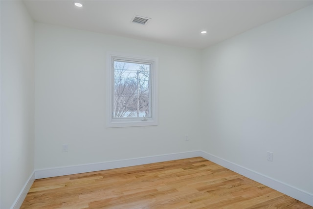 spare room with baseboards, visible vents, light wood-style flooring, and recessed lighting