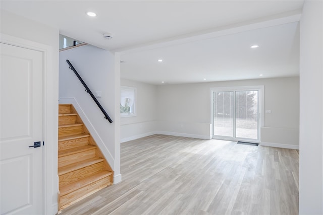 interior space with baseboards, light wood-style floors, stairs, and recessed lighting