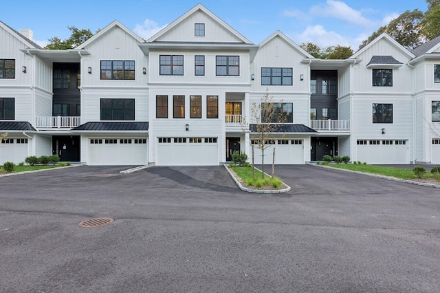 133 Spring Rd Unit 8, Huntington, NY 11743 - view of property featuring driveway, a standing seam roof, board and batten siding, an attached garage, and metal roof