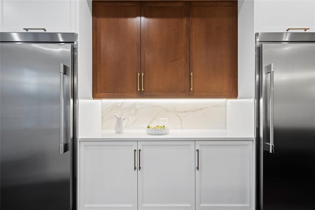 133 Spring Rd Unit 8, Huntington, NY 11743 - kitchen featuring tasteful backsplash, light countertops, and stainless steel built in fridge