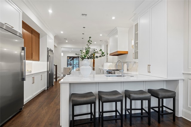 133 Spring Rd Unit 8, Huntington, NY 11743 - kitchen featuring visible vents, built in refrigerator, custom range hood, high end fridge, and a sink