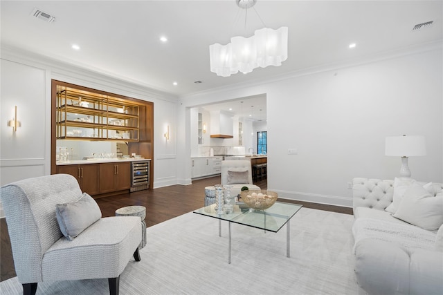 133 Spring Rd Unit 8, Huntington, NY 11743 - living area featuring visible vents, wine cooler, ornamental molding, indoor wet bar, and wood finished floors