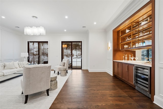 133 Spring Rd Unit 8, Huntington, NY 11743 - living room with dark wood finished floors, crown molding, beverage cooler, and indoor bar