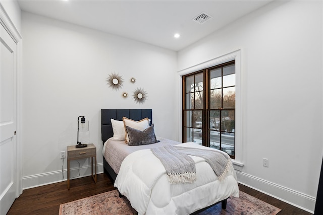133 Spring Rd Unit 8, Huntington, NY 11743 - bedroom with wood finished floors, visible vents, and baseboards