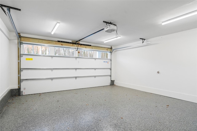 133 Spring Rd Unit 8, Huntington, NY 11743 - garage featuring a garage door opener and baseboards