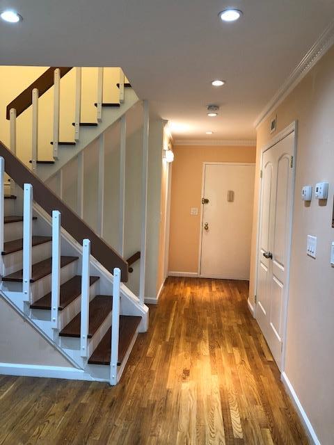 12-31 Robin Ln Unit 52L, Bayside, NY 11360 - hall featuring ornamental molding, stairway, wood finished floors, recessed lighting, and baseboards