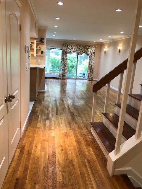 12-31 Robin Ln Unit 52L, Bayside, NY 11360 - hall featuring stairs, wood finished floors, recessed lighting, and crown molding