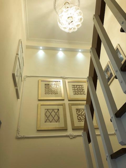 12-31 Robin Ln Unit 52L, Bayside, NY 11360 - stairs featuring a chandelier