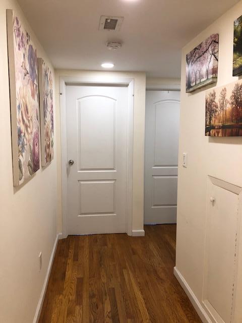 12-31 Robin Ln Unit 52L, Bayside, NY 11360 - hallway with dark wood-type flooring and baseboards