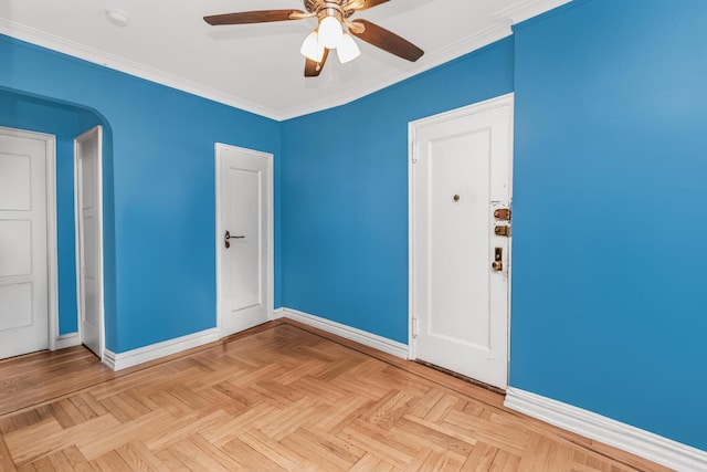 empty room with baseboards, ceiling fan, and crown molding