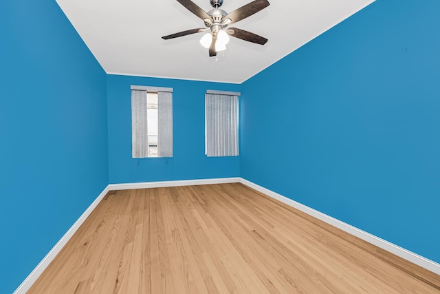 unfurnished room with a ceiling fan, baseboards, and wood finished floors
