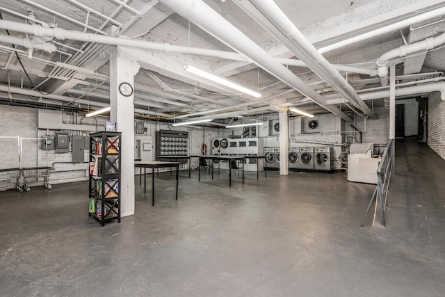 unfinished below grade area with washing machine and clothes dryer and electric panel