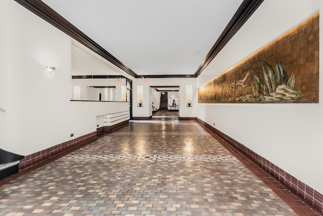 hallway with brick floor, baseboards, and crown molding