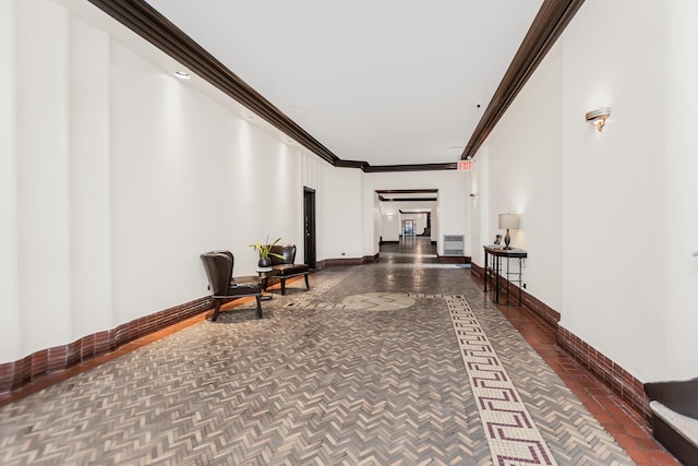 hallway featuring baseboards and ornamental molding