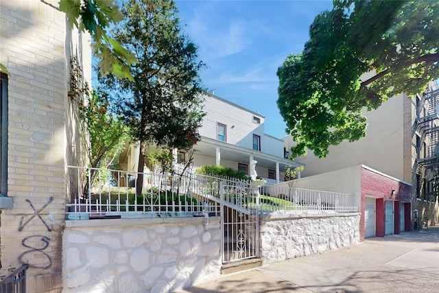 32-25 30th St, Long Island City, NY 11106 - view of front facade featuring fence and brick siding