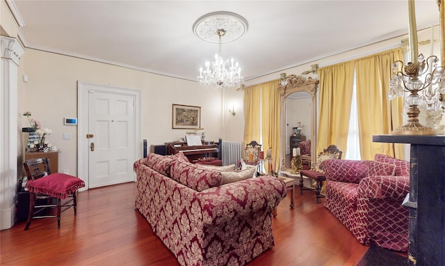 32-25 30th St, Long Island City, NY 11106 - living room featuring radiator, an inviting chandelier, wood finished floors, and crown molding