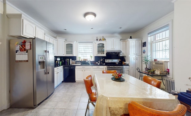32-25 30th St, Long Island City, NY 11106 - kitchen featuring stainless steel appliances, white cabinets, glass insert cabinets, crown molding, and exhaust hood