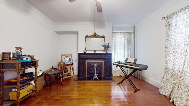 32-25 30th St, Long Island City, NY 11106 - living area featuring a ceiling fan, wood finished floors, baseboards, a fireplace, and crown molding