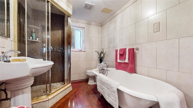 32-25 30th St, Long Island City, NY 11106 - bathroom featuring visible vents, a freestanding bath, a shower stall, tile walls, and toilet