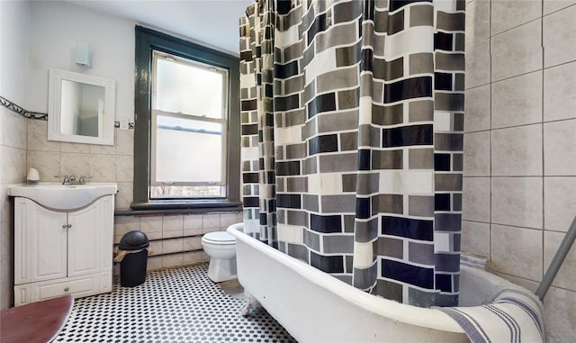 32-25 30th St, Long Island City, NY 11106 - bathroom with toilet, tile walls, shower / tub combo with curtain, and vanity