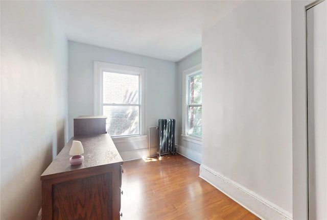 32-25 30th St, Long Island City, NY 11106 - unfurnished office featuring radiator heating unit, wood finished floors, and baseboards