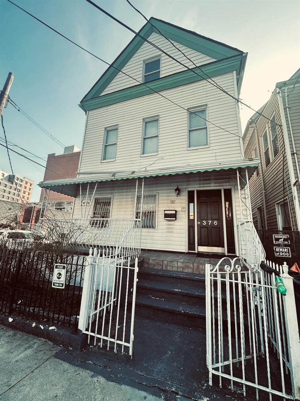 376 Bronx Park Ave, Bronx, NY 10460 - view of front of property with a fenced front yard, a porch, and a gate