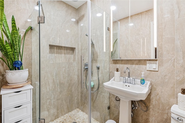 bathroom featuring tile walls and a stall shower