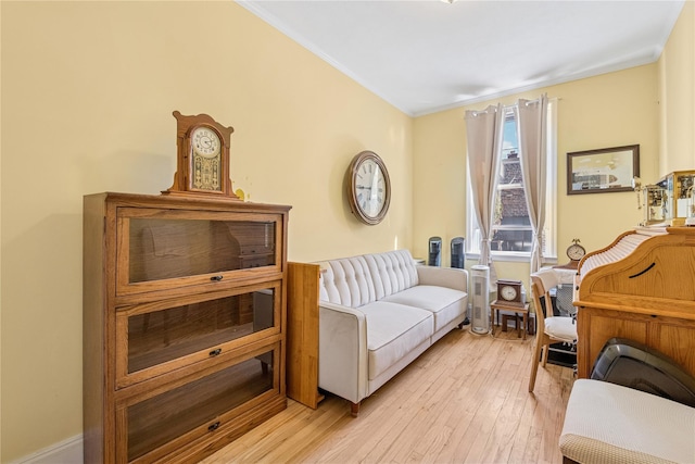 sitting room with light wood-style floors and ornamental molding