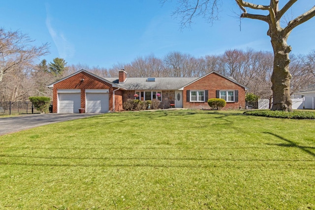 single story home featuring a front yard, fence, driveway, an attached garage, and a chimney