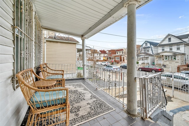 balcony featuring a residential view and covered porch
