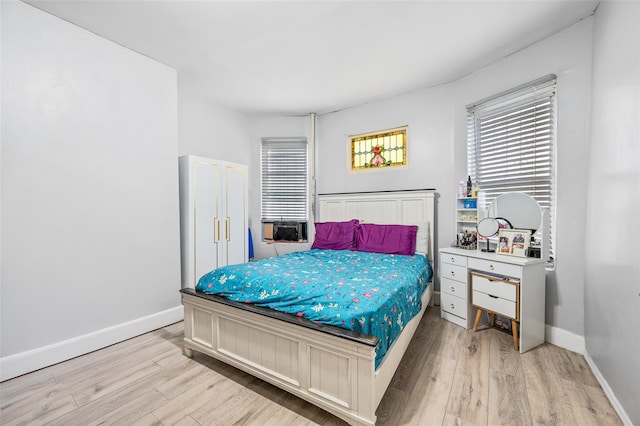 bedroom with baseboards and light wood finished floors