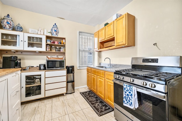 kitchen with wine cooler, appliances with stainless steel finishes, open shelves, and a sink