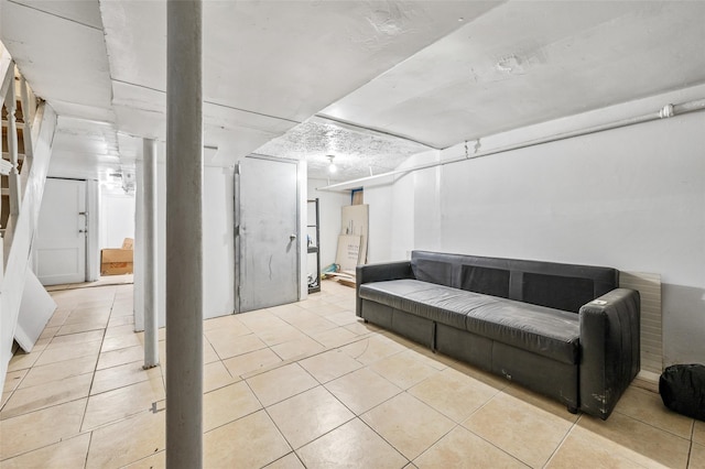 finished below grade area featuring tile patterned floors