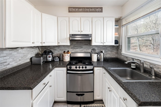 kitchen featuring a sink, white cabinetry, under cabinet range hood, and stainless steel range with gas cooktop