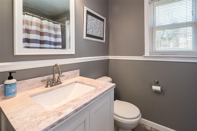 bathroom featuring toilet, a shower with curtain, and vanity