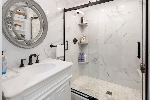 full bathroom with a marble finish shower and vanity
