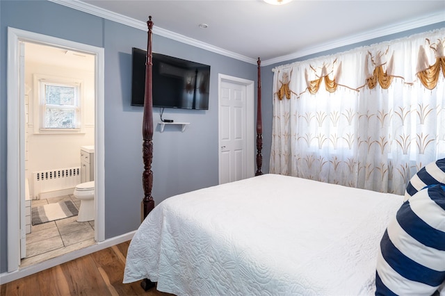 bedroom with wood finished floors, connected bathroom, radiator heating unit, baseboards, and crown molding