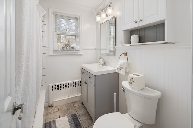 bathroom featuring tile patterned flooring, radiator, toilet, vanity, and crown molding