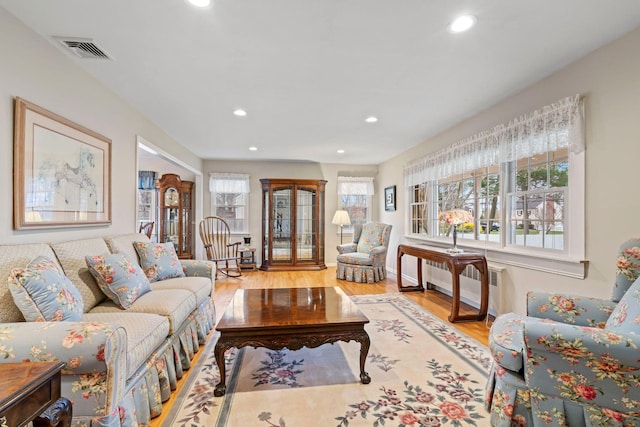 14 Hillside Ave, Saint James, NY 11780 - living area with recessed lighting, wood finished floors, and radiator heating unit